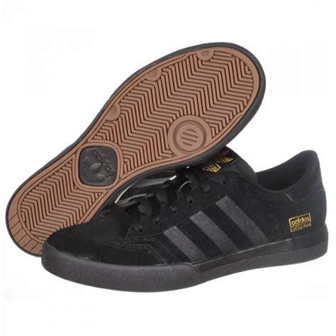 all black adidas skate shoes.